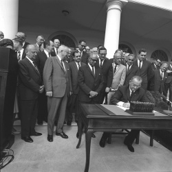President Lyndon B. Johnson signs Public Law 90-130. The Nov. 8, 1967,  event opened promotions